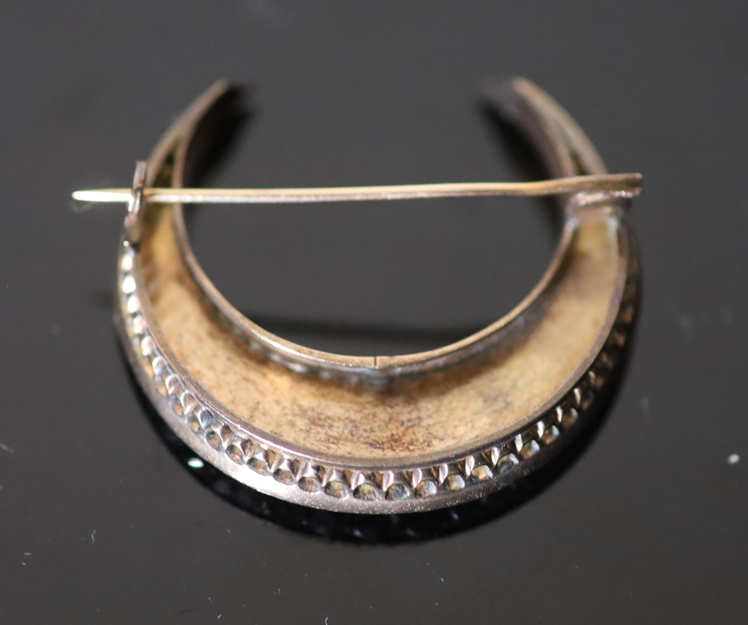 A 19th century French gold and foil backed graduated rose cut diamond set crescent brooch,